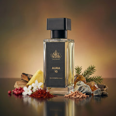 Perfume bottle labeled 'Aura 10' by 'Sia Scents' with natural elements on a reflective surface.
